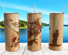 three wooden tumblers with fishing images on them