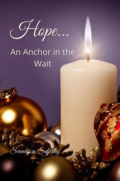 a candle and ornaments with the words hope an anchor in the wait