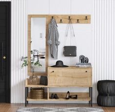 a white room with a black door and some shoes on the floor next to it