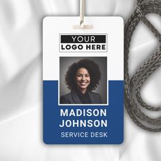 an id badge is attached to a lanyard that has a photo of a smiling woman on it