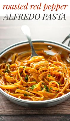 a bowl filled with pasta on top of a wooden table