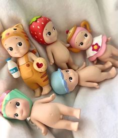 several baby dolls laying on top of each other