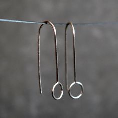 Minimalist silver wire earrings, dainty and delicate.  These geometric threaders are super lightweight and very comfortable to wear. You'll forget that you have them on. They look awesome for any occasion, discrete and simple but unique and elegant.  The total drop length measures about 1 3/16 inches (30mm). The idea behind this design was to create a pair of earrings with an elegant and simple look easy to match with any outfit. Choose between solid silver, 14k rose gold filled brass or 14k yellow gold filled brass in the drop down box. The wire is hardened, which make the earrings more resistant against deforming. You will receive these earrings in box ready to give as gift. For more unique jewelry: www.etsy.com/shop/BGLASSbcn Follow me on Instagram: @bgalssbcn Thank you for visiting my Affordable Minimalist Sterling Silver Earrings, Affordable Minimalist Wrap Earrings, Cheap Minimalist Silver Jewelry, Drop Earrings Simple Short Silver, Cheap Silver Minimalist Linear Earrings, Cheap Minimalist Dangle Jewelry, Cheap Hand-strung Minimalist Jewelry, Minimalist Hypoallergenic Wrap Earrings, Affordable Hypoallergenic Minimalist Wrap Earrings