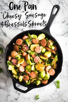 a skillet filled with brussels sprouts and sausage