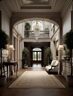 an elegant entry way with two couches and lamps on either side of the door