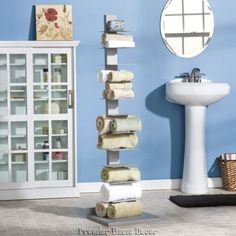 a bathroom with blue walls and towels on the shelf next to the sink is shown