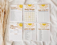 four baby shower games laid out on top of a white sheet with dried grass next to them