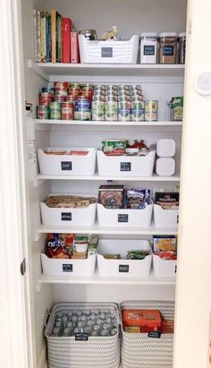 an organized pantry with white bins filled with food