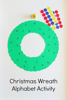 the christmas wreath alphabet activity book is open to show it's letters and numbers