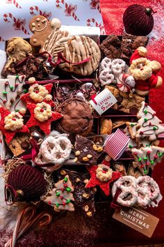 a box filled with lots of different types of cookies and pastries on top of a table