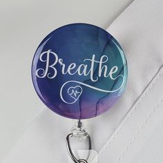 "Funny Nurse Badge Reel with \" Breathe\" in white with a little cardio heart, over a blue and purple watercolor background. ID Badge reels are ideal for Medical staff, Nurses, Doctors, Teachers, Students, Government and Transportation workers who are required to wear identification. I say...why not look stylish while wearing one! You can choose: SWIVEL CLIP Reels are the best choice for Doctors, Nurses and Hospital Staff! Clip attaches to any part of any garment and is great for connecting to a Customizable White Badge Reel, Customizable Adjustable White Badge Holders, Adjustable Customizable White Badge Holders, Adjustable White Badge Holder For Personal Use, Adjustable White Badge Holder As A Gift, Purple Watercolor Background, Lanyard Id Holder, Stethoscope Tag, Stethoscope Id Tag