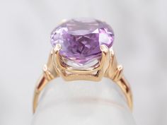 This ring is truly gorgeous! A large and beautiful purple Amethyst sits in the center, with an amazing cut and vibrant purple color that flickers with hints of violet and raspberry, a simple yellow-gold mounting and four prongs are all this stone needs to frame it to perfection!Metal: 14K Yellow GoldGem: Amethyst 8.88 CaratsGem Measurements: 16.1 x 12.2 mm, OvalRing Size: 7.75Marks: “14K” Stamped on the inside band Classic Purple Solitaire Ring, Classic Diamond Cut Purple Amethyst Ring, Classic Purple Amethyst Ring With Prong Setting, Classic Purple Sapphire Ring With Prong Setting, 14k Gold Brilliant Cut Purple Amethyst Ring, Yellow Gold Amethyst Ring With Polished Finish, Luxury 14k Gold Hallmarked Amethyst Ring, Luxury Yellow Gold Amethyst Ring Collectible, 14k Yellow Gold Polished Amethyst Ring