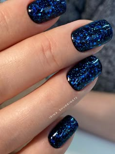 19 Gorgeous Winter Acrylic Nail Colors for 2023-2024 Dark Glitter Gel Nails, Glitter Gel Acrylic Nails, Black Nails Blue Glitter, Blue Dip Nails With Glitter, Black And Blue Glitter Nails, Blue Dipped Nails Ideas, Sparkly Nails Blue, Black Nails With Blue Glitter, Navy Sparkle Nails