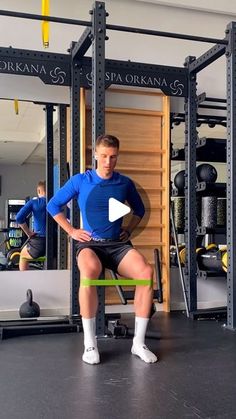 a man sitting on top of a bench in a gym