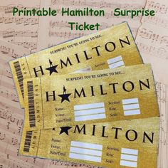 two tickets are sitting on top of sheet music with the words, printable hamilton surprise ticket