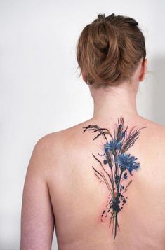 the back of a woman's neck with blue flowers on her upper and lower part