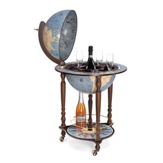 an old world globe with wine glasses on it