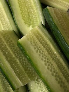 cucumber slices are stacked up on top of each other in a close up view