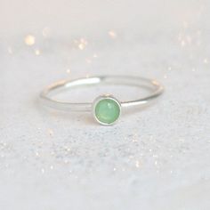 Chrysoprase represents and promotes, joy, love, happiness, truth, forgiveness and healing. Green chrysoprase is the rarest and most valuable of the chalcedony family, which is a type of quartz. It can be used as an alternative stone to represent May birthdays. The sterling silver band creates a cool, complimentary setting for this minty, natural chrysoprase stone. ** Last photo shows style / pairing sample, additional rings sold separately. **{DETAILS}* natural 4 mm chrysoprase stone* 1.3 mm ste Chrysoprase Ring, Green Gemstone Ring, May Birthday, Stack Ring, Ring Stack, May Birthstone, Ring Minimalist, Sterling Silver Bands, Stacking Ring