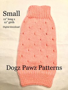 the small dog sweater is knitted in pink and has holes at the bottom, along with