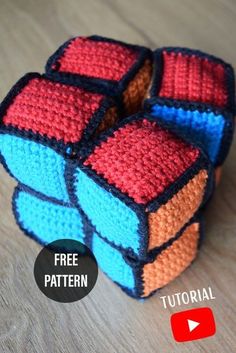 a crocheted rubik cube sitting on top of a wooden table with the text free pattern below it