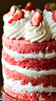 a red velvet cake with white frosting and strawberries on top