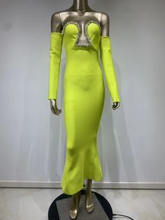 a mannequin dressed in a yellow dress