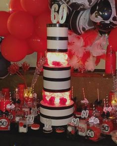 a birthday cake with candles and balloons in the background at a 60th birthday party or celebration