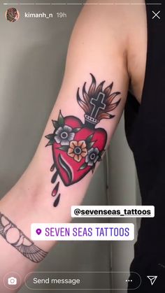 a person with a heart tattoo on their arm