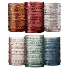 four different colored glass cups sitting next to each other