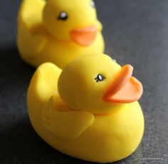 two yellow rubber ducks sitting next to each other