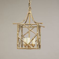 a hanging light fixture with two candles in it