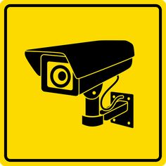 a black and yellow sign with a camera on it