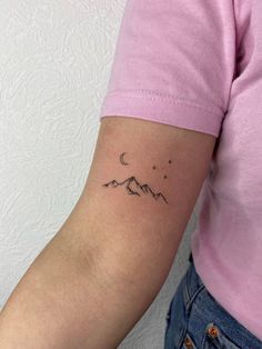 a woman's arm with a small tattoo on the left side of her arm