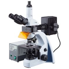 a microscope is shown with the light on it's side and some other equipment in front of it