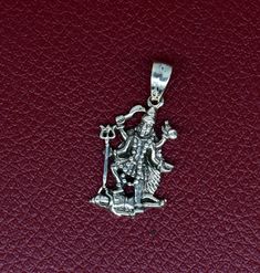 Indian Hindu Idols Blessing Goddess Kali maa vintage antique style stunning divine pendant, best gifting unisex jewelry from India. Metal-925 sterling silver. Item type-Pendant Weight-2.960 grams. Height-2.8 centimeter. Width-1.2 centimeters. Stamped-925. Finish-Oxidized. note: chain is not included in this price Make excellent gifting and collectible pieces(gifts for birthdays, weddings, anniversaries, mother's day, fathers day, Christmas day,) We take absolute care of precious jewels that are Symbolic Jewelry For Navratri Rituals, Symbolic Silver Jewelry For Puja, Silver Spiritual Jewelry For Navratri, Spiritual Silver Jewelry For Navratri, Symbolic Sterling Silver Jewelry For Puja, Spiritual Sterling Silver Jewelry For Navratri, Sterling Silver Engraved Jewelry For Puja, Engraved Spiritual Jewelry For Navratri, Spiritual Engraved Jewelry For Navratri