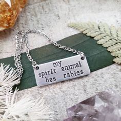 It wasn't me. It was my spirit animal. "My spirit animal has rabies" is stamped onto a silver bar pendant.  These funny stamped necklaces make a great gift.  - "My spirit animal has rabies" ORIGINAL Wanderlust Hearts jewelry quote - Stamped aluminum bar pendant - Stainless steel chain - Measures 1.25"x .5" 2017©Wanderlust Hearts designs All Rights Reserved. WanderlustHearts' Jewelry and Accessories are the intellectual property of WanderlustHeartShop My designs are not to be duplicated in part o Western Metal Stamped Necklace, Stamped Jewelry Ideas, Hearts Jewelry, Funny Jewelry, Stamped Necklaces, Metal Stamped Jewelry, Animal Necklace, My Spirit Animal, Jewelry Quotes