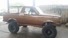 a brown truck parked inside of a garage