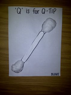 a piece of paper with a drawing of a spoon and the words q is for q - tip on it