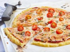 a pizza sitting on top of a pan covered in cheese and tomatoes