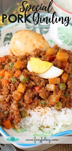 a plate filled with rice and meat on top of a green and white table cloth