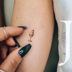 a woman's arm with a small tattoo on the left side of her body