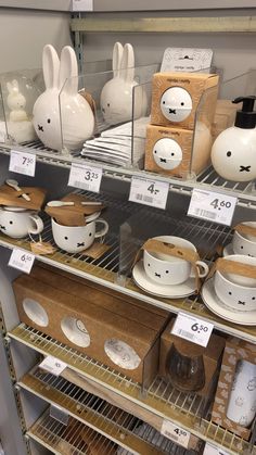 the shelves are filled with pottery and other items for sale at the store's booth