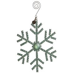 a green snowflake ornament hanging from a hook on a white background