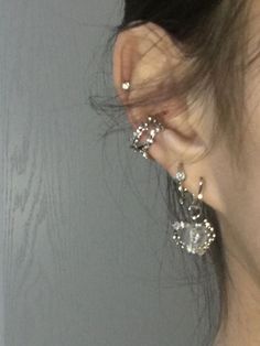 a close up of a person's ear wearing earrings