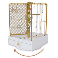 a gold and white birdcage with jewels in it