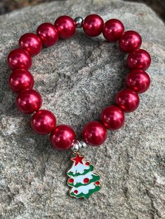 This bracelet is made with red pearl beads, silver beads and has an enamel Christmas tree charm. Note: Colors may vary depending on your monitor  I do have other colors for the necklace strands for both multi and single strand.  If you are looking for a different variation, feel free to touch base with me and I can let you know if I have what you are looking for. Shipping Info: All orders are shipped from Canada and they are sent through Canada Post.  If you would like expedited/faster shipping, Red Round Beads Jewelry For Christmas, Red 8mm Beads Jewelry For Festive Occasion, Red Holiday Bracelet, Red Bracelet Jewelry For Holidays, Silver Round Beads Jewelry For Christmas, Silver Jewelry With Round Beads For Holidays, Silver Beaded Christmas Bracelets As Gifts, Silver Beaded Christmas Gift Bracelets, Silver Beaded Bracelets For Christmas Gift