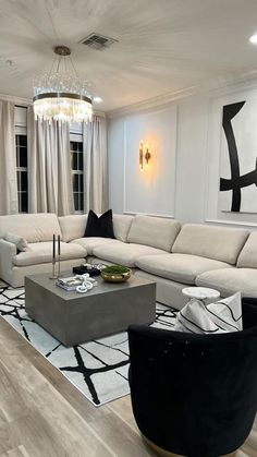 a living room filled with furniture and a chandelier