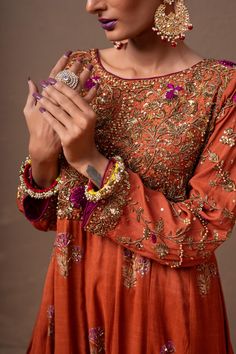 A beautiful vermillion colored, hand-embroidered dress ideal for weddings. The raw silk block-print fabric features ethnic embroidery on the front of the body, and the touch of handwork gives it a beautifully traditional look.3-Piece SuitReady to wear Eid Raw Silk Dress With Intricate Embroidery, Eid Dress With Intricate Embroidery In Raw Silk, Traditional Designer Dress With Multicolor Embroidery, Transitional Designer Dresses In Dola Silk, Raw Silk Anarkali Set With Floral Embroidery For Wedding, Transitional Designer Dress In Dola Silk, Designer Bollywood Embroidered Saree Dress, Bollywood Style Designer Embroidered Saree Dress, Fitted Raw Silk Dress With Dabka Work