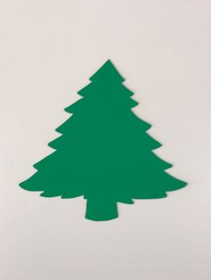 a paper cut out of a green christmas tree